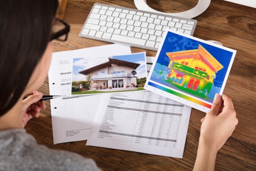 Person Analyzing The Heat Loss Of A House