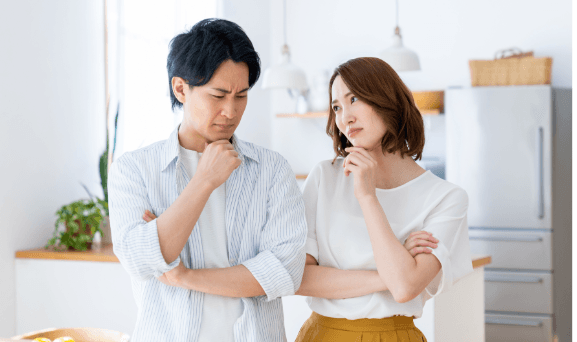 悩む夫婦　腕組み　写真